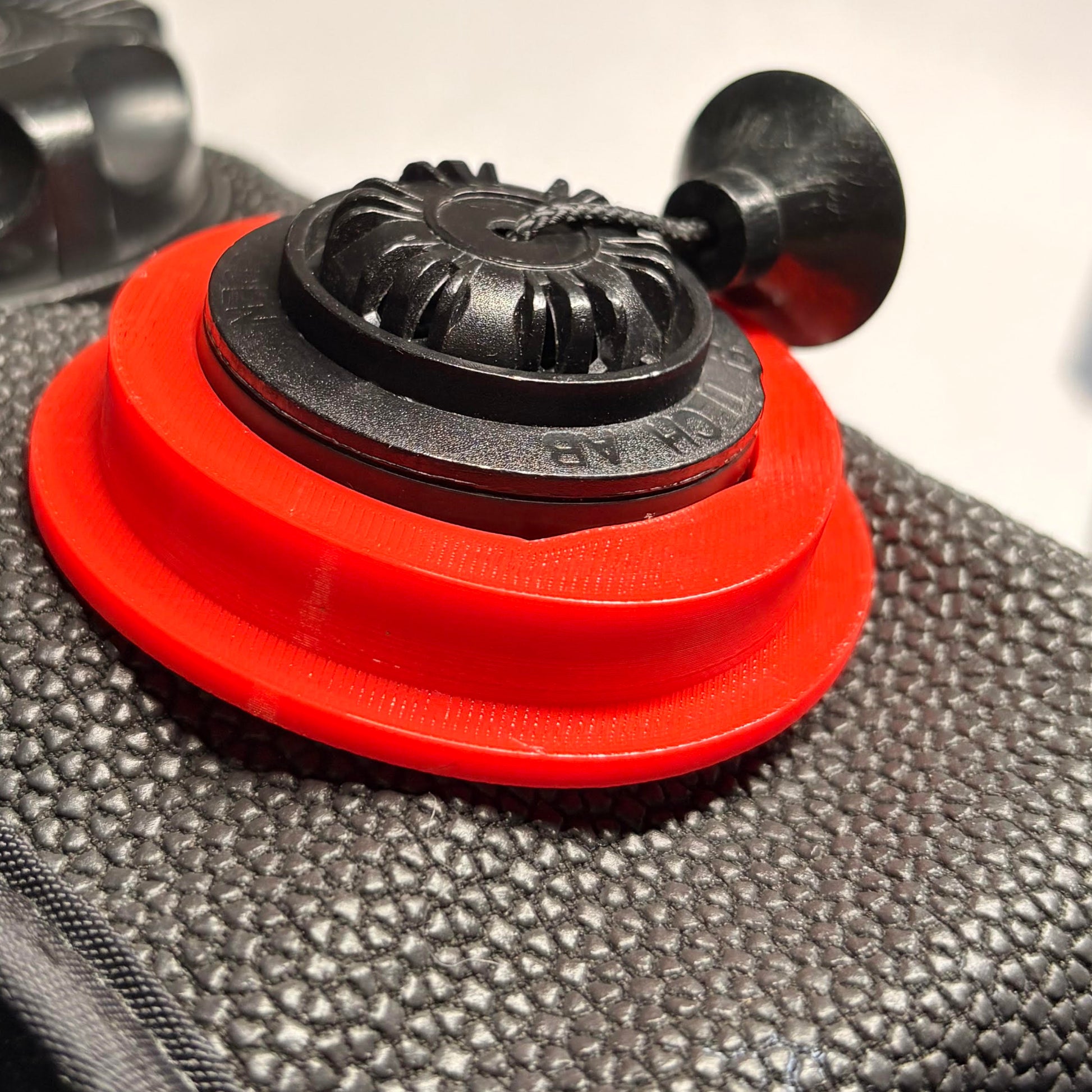 Red pull dump retention ring installed on a re breather 