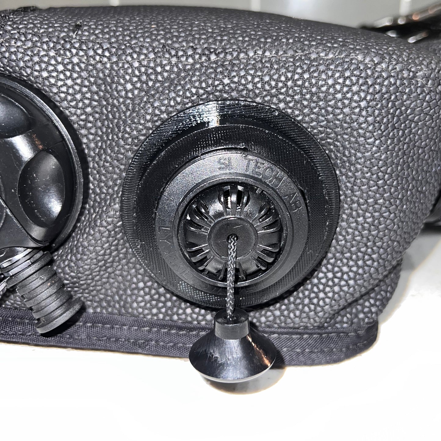 Black Pull Dump retention ring installed on a re-breather