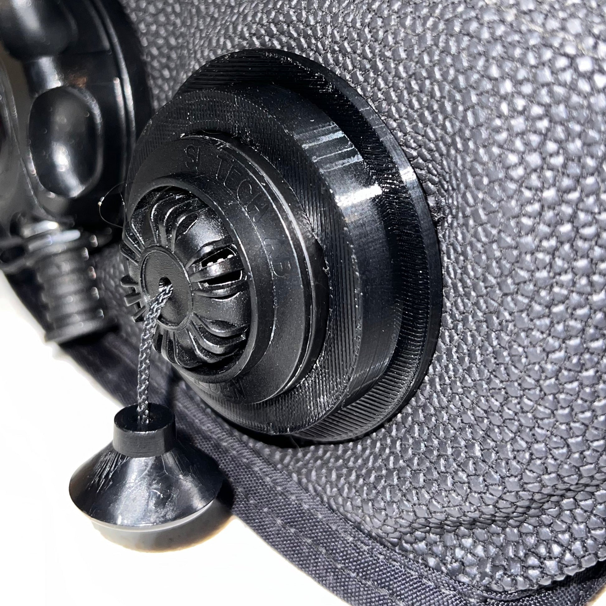 Black Pull Dump retention ring installed on a re-breather